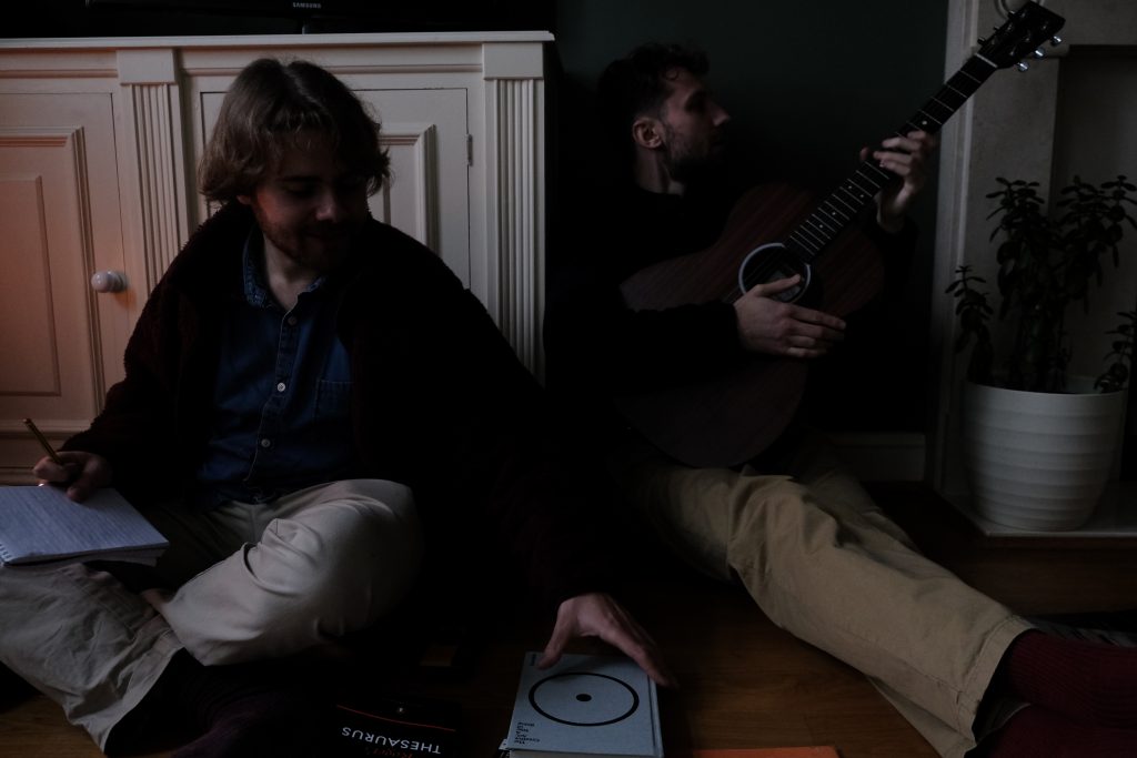 Image of two people working together to finish a song